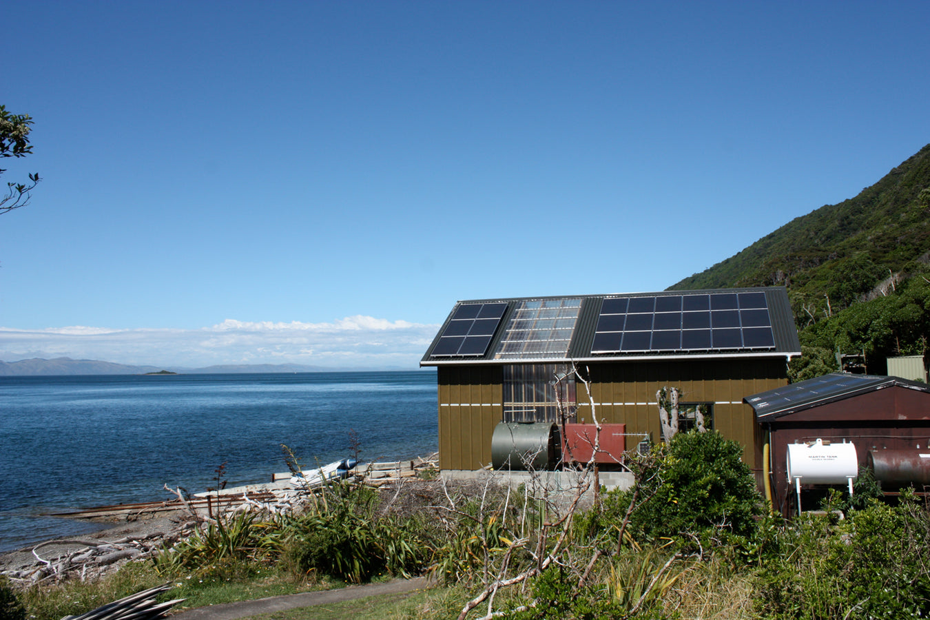 Off Grid Solar Array On Secluded Residence with Oceanic Backdrop